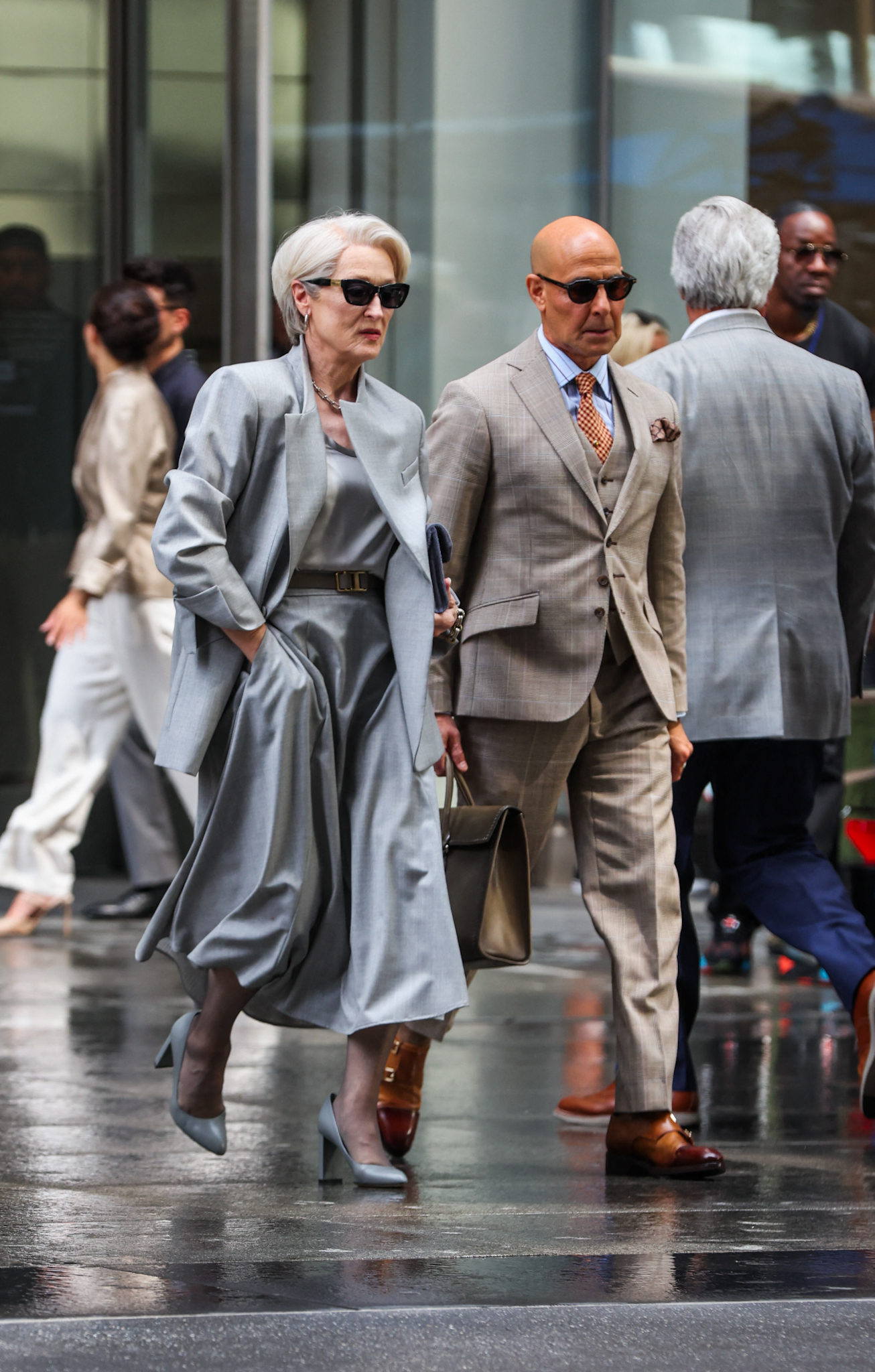 Meryl Streep & Stanley Tucci get into character while on set filming The Devil Wears Prada 2 this afternoon in New York City